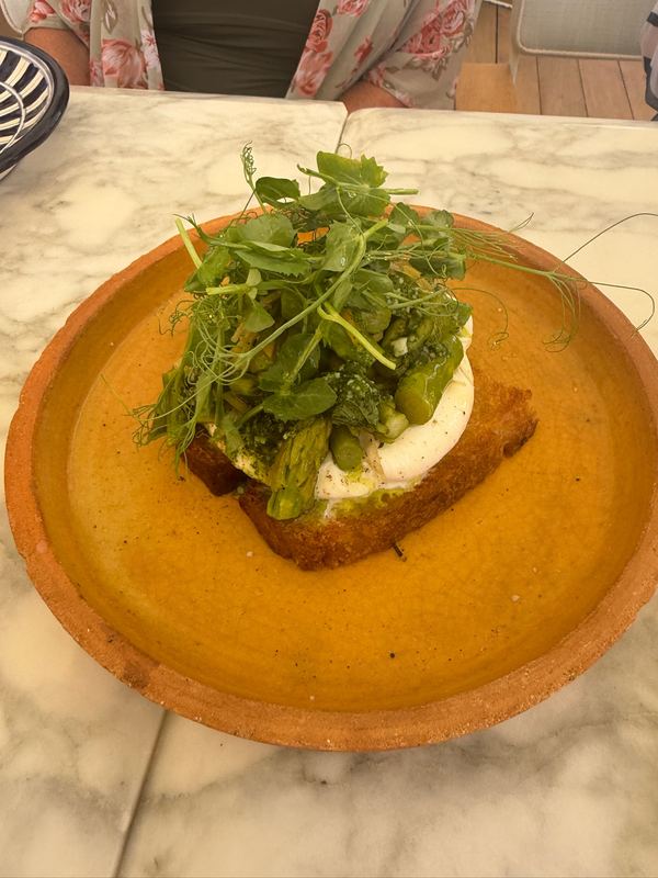 Burrata on grilled bread with asparagus and pea shoots.