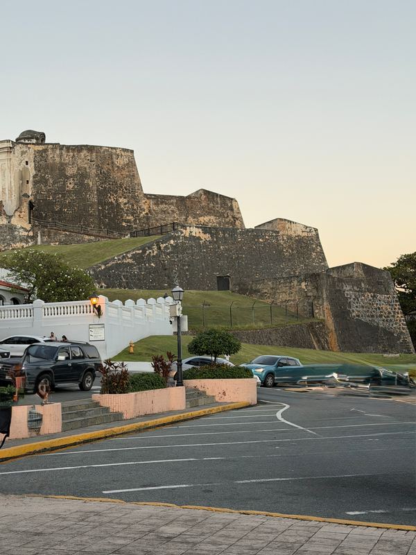 The bastions of Castillo San Cristóbal above the road at dusk