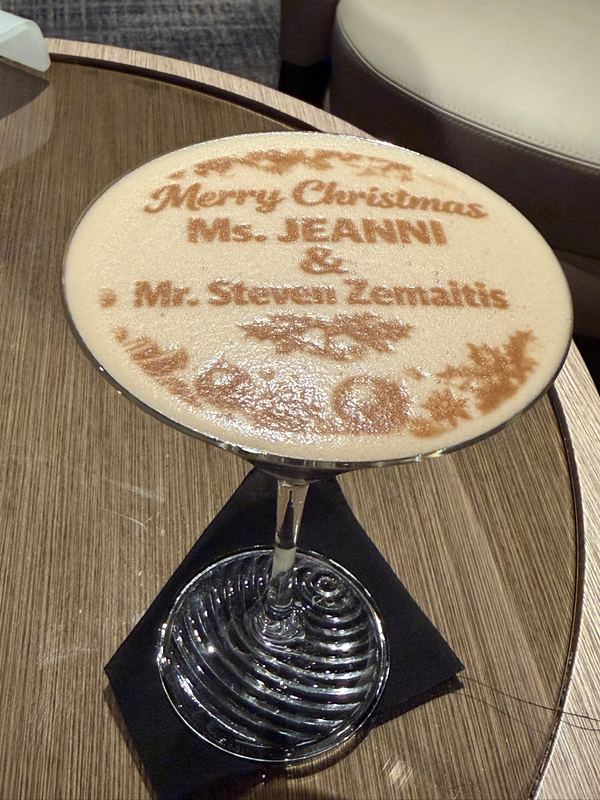 A cocktail with a Merry Christmas greeting to Ms Jeannie and Mr Steven Zemaitis stencilled on the foam