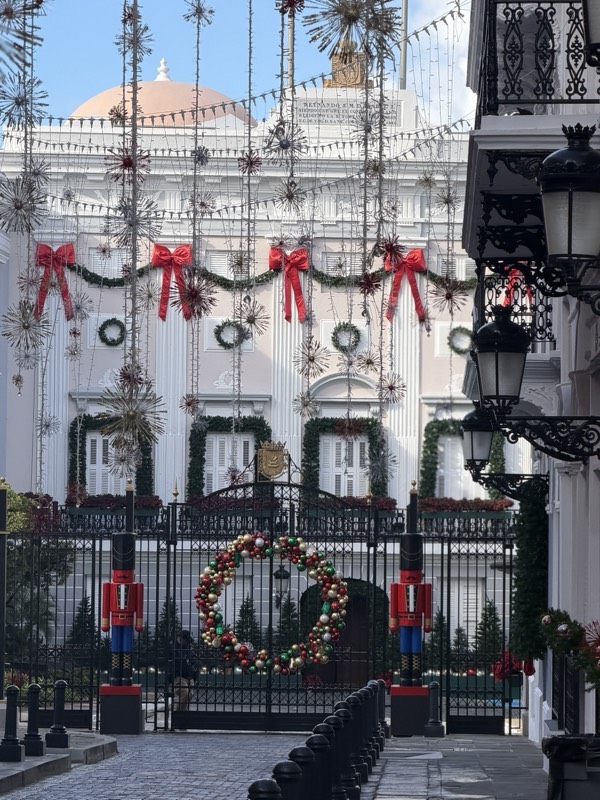White colonial facade dressed with wreaths, ribbons and nutcrackers
