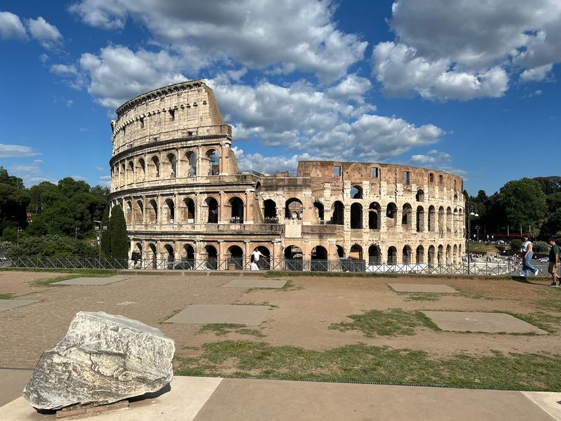 The Colosseum from the piazza, a fallen block of travertine in the foreground