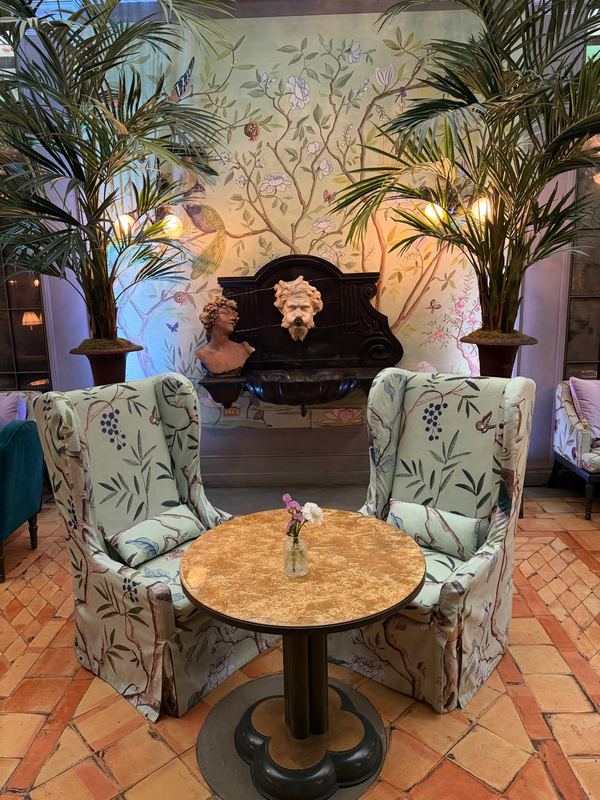 Two wing chairs and a marble table in a hotel lounge, Florence