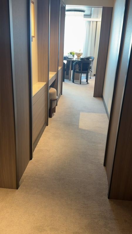 The passage into the Grand Suite, a dressing table on one side and the dining table and terrace ahead