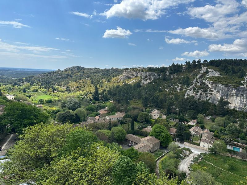 The valley below Les Baux-de-Provence, limestone cliffs and pines above the farmhouses