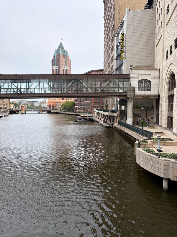 The Milwaukee River downtown, a glass skywalk over it and the Milwaukee Center tower behind