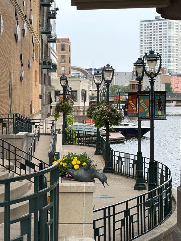 The RiverWalk railings and lamps, a bronze duck in the planter