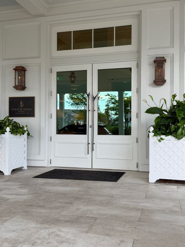 The front doors, lanterns and planters either side