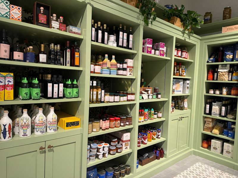 The pantry shelves at Naples Trading Company: oils, sauces and tins