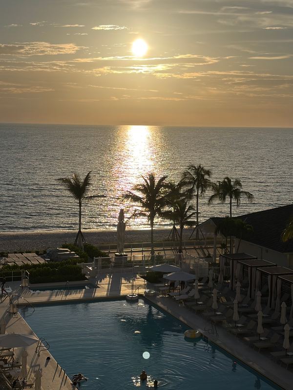 Late sun over the Gulf and the pool from an upper balcony
