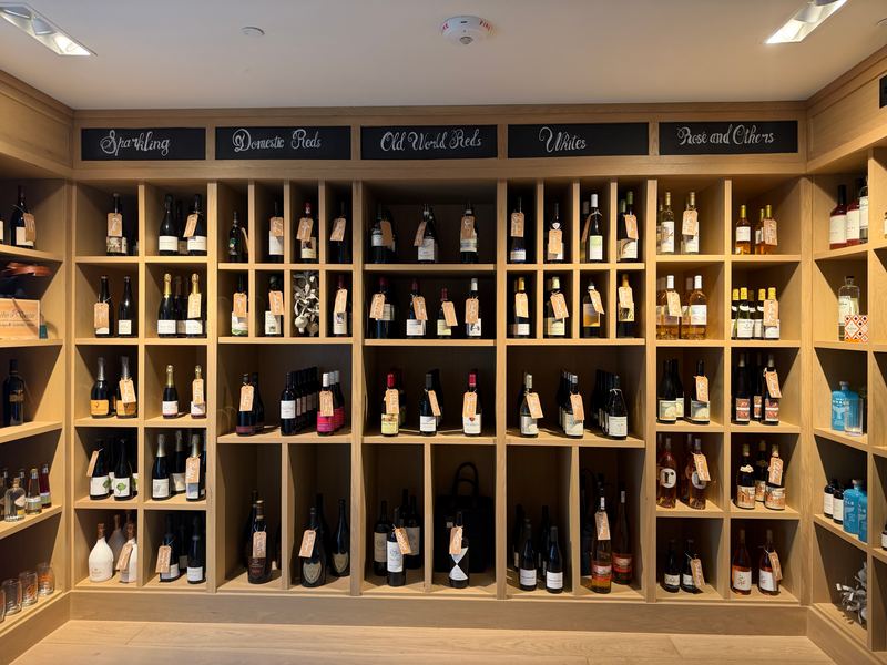 The wine room at Naples Trading Company, shelves by style