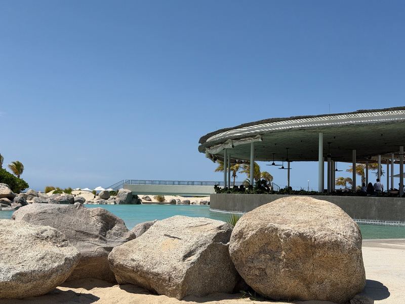 Granite boulders at the edge of the pool at Costa Palmas, the pavilion behind