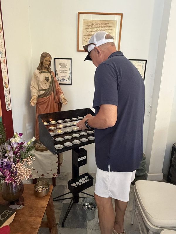 Steve lighting a candle at a shrine inside the church