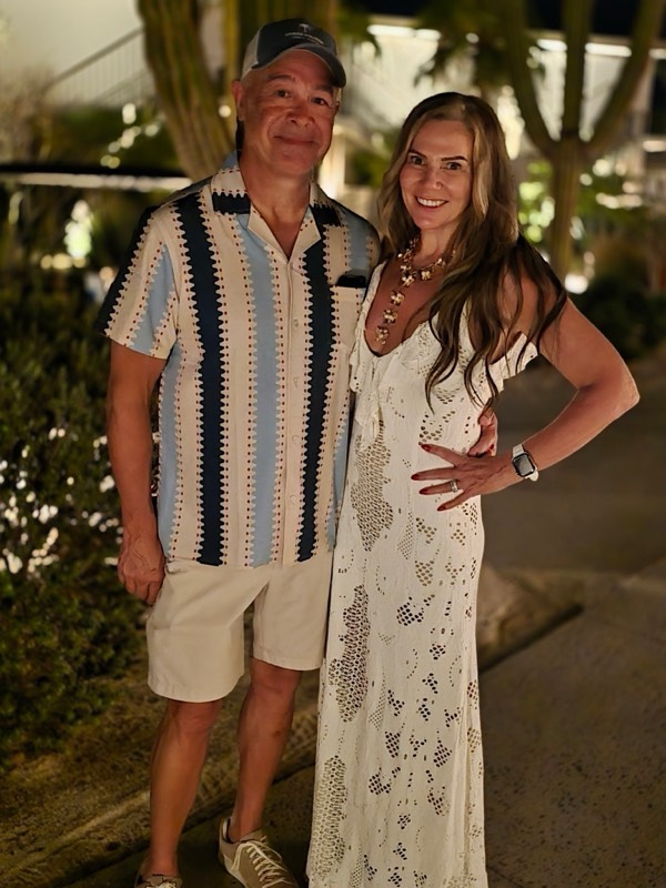 Steve and Jeannie on a lamplit path at the resort, ready for a night out