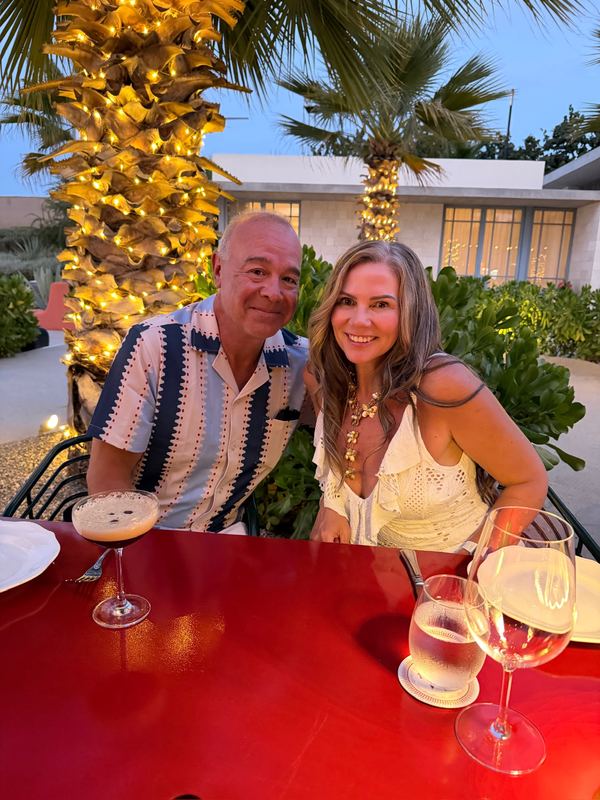 Steve and Jeannie at dinner at Mozza Baja, under the lit palms