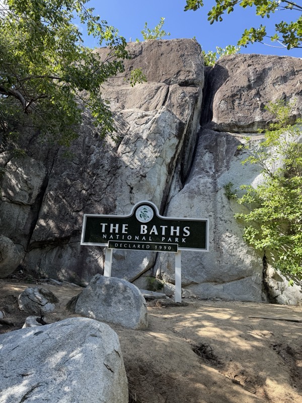 The Baths National Park sign among granite boulders at the trail head, Virgin Gorda
