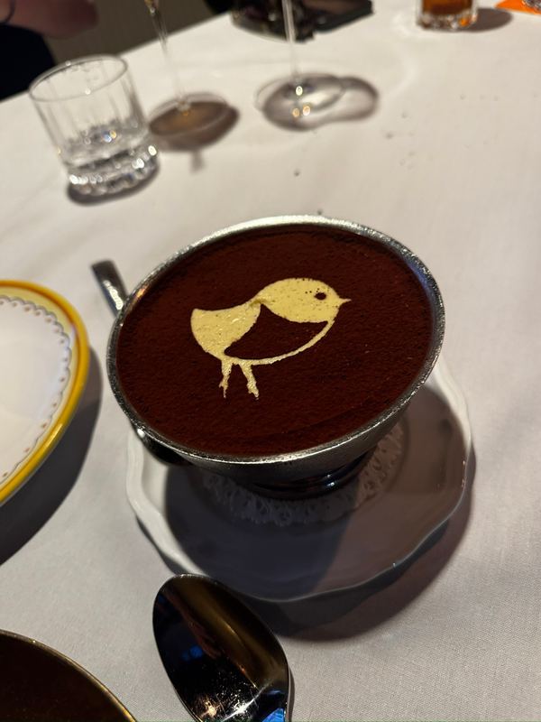 A tiramisu in a cup, the resort's bird stencilled in cocoa on top