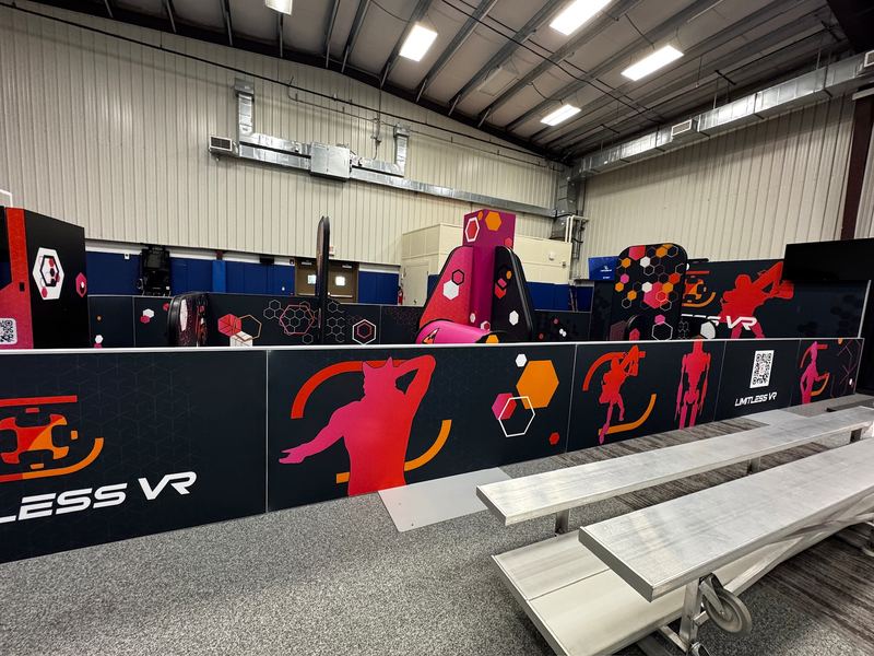 VR bays with bright graphic panels in a high-ceilinged hall